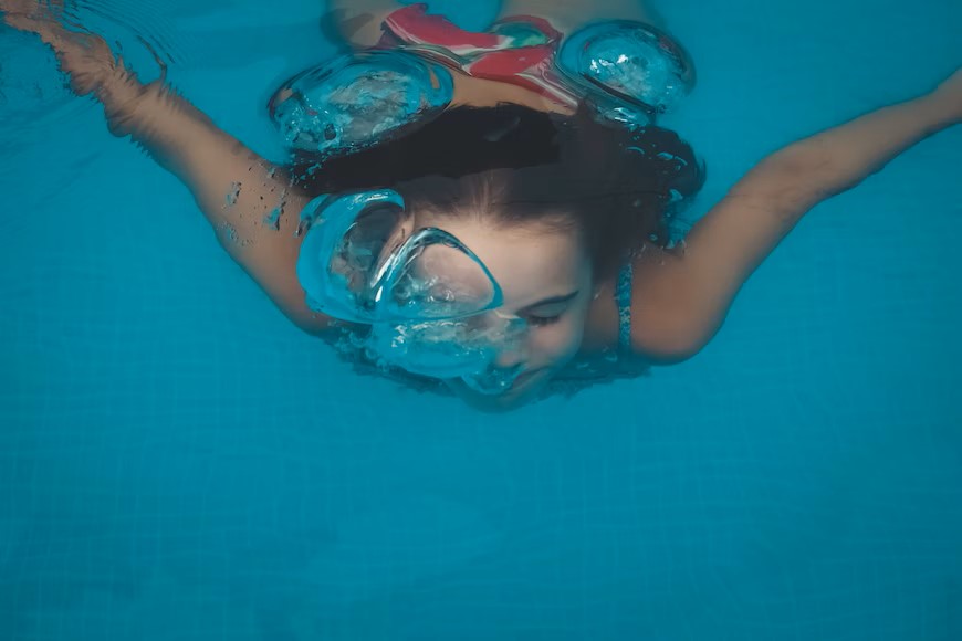 kid underwater swimming